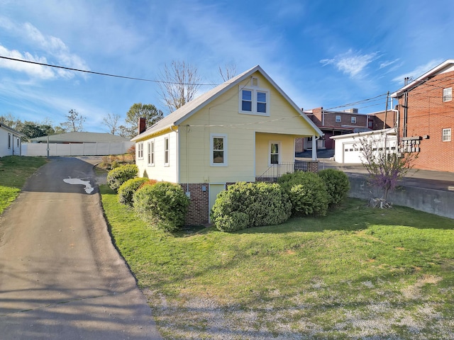 bungalow-style home featuring a chimney and a front yard