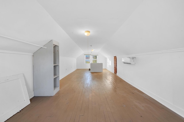 bonus room with baseboards, vaulted ceiling, and hardwood / wood-style flooring