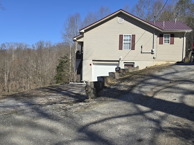 view of home's exterior featuring metal roof and an attached garage