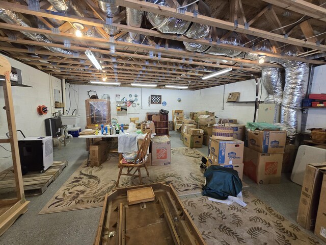 unfinished basement with a sink and concrete block wall