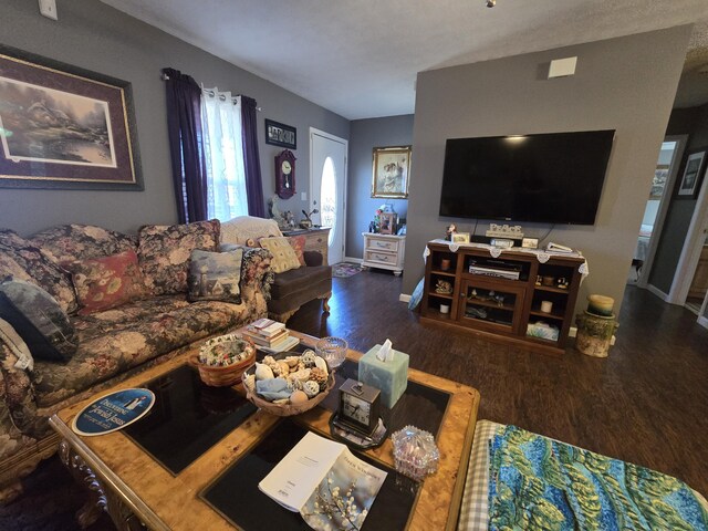 living area featuring baseboards and wood finished floors