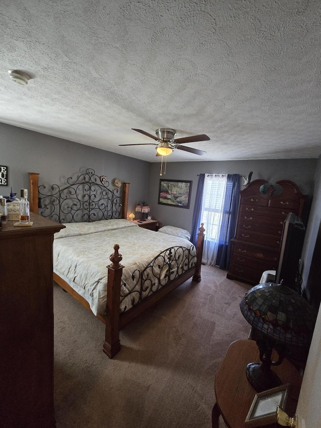 bedroom with carpet, a ceiling fan, and a textured ceiling