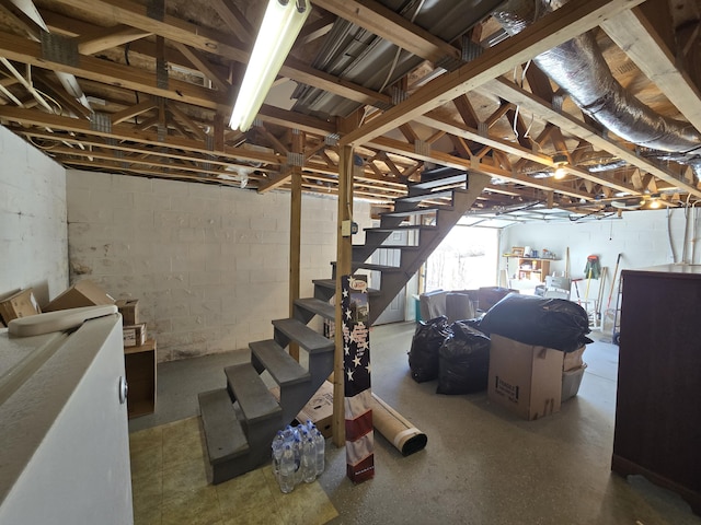 basement with stairway and concrete block wall