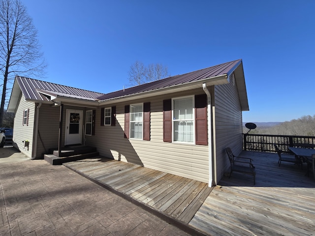 744 Don Greene Rd, Sneedville, TN 37869 - back of property featuring metal roof, a deck, and entry steps