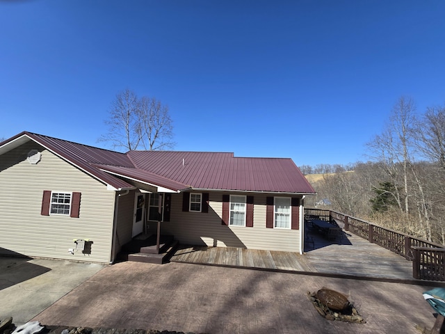 view of front of house with metal roof, a patio, and a deck