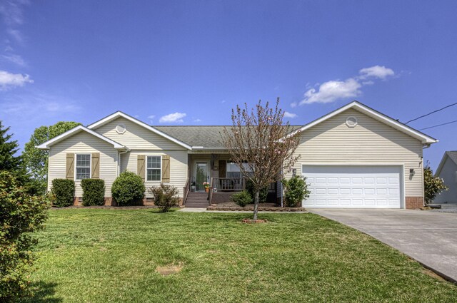 single story home with a porch, driveway, a front lawn, and an attached garage