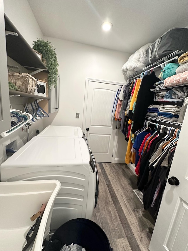 laundry room featuring independent washer and dryer and dark hardwood / wood-style floors