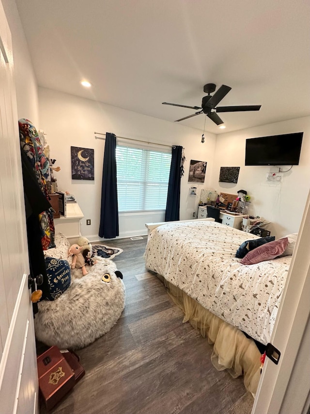 bedroom with ceiling fan and dark wood-type flooring