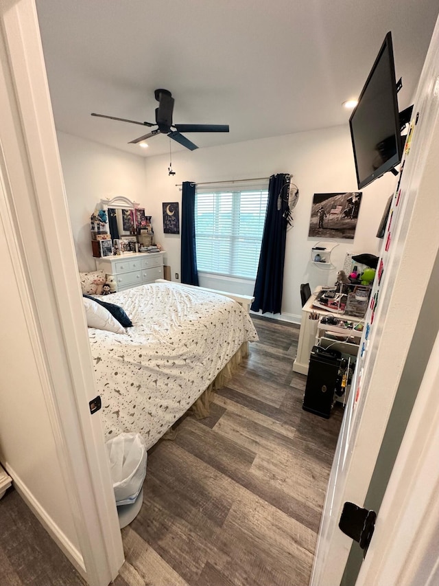 bedroom featuring ceiling fan and dark hardwood / wood-style floors