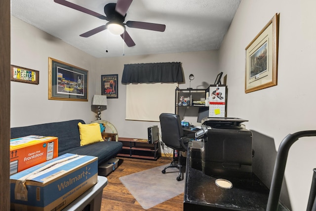 office area featuring a textured ceiling, dark hardwood / wood-style flooring, and ceiling fan