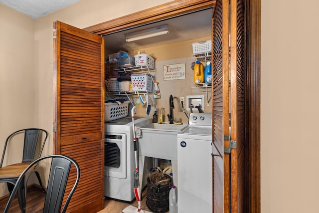 laundry room featuring separate washer and dryer and a textured ceiling