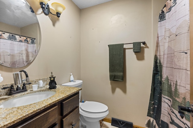 bathroom featuring tile patterned floors, vanity, and toilet