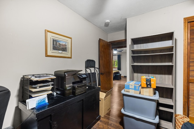 office featuring dark hardwood / wood-style floors, ceiling fan, and a textured ceiling