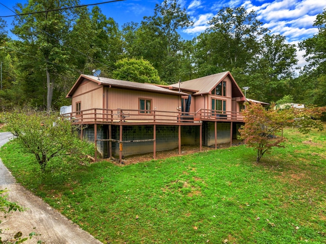 back of house featuring a yard and a wooden deck