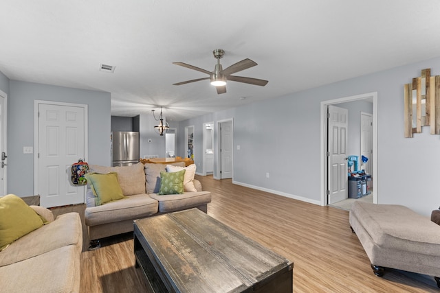 living room featuring ceiling fan and light wood-type flooring