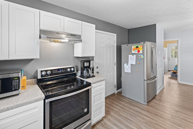 kitchen featuring white cabinets, light hardwood / wood-style flooring, stainless steel appliances, and a textured ceiling