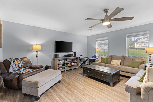 living room featuring ceiling fan and light hardwood / wood-style flooring