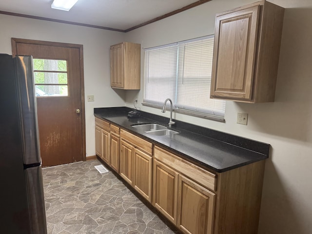 838 Pineridge Rd, Dandridge, TN 37725 - kitchen with freestanding refrigerator, stone flooring, dark countertops, and ornamental molding