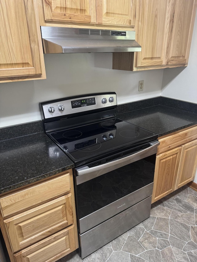 838 Pineridge Rd, Dandridge, TN 37725 - kitchen with stainless steel electric range oven, under cabinet range hood, stone finish floors, light brown cabinetry, and dark stone countertops