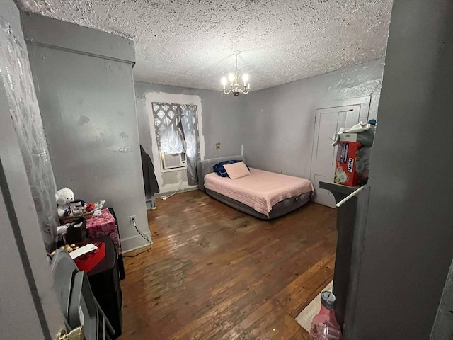 207 E 2nd N St, Morristown, TN 37814 - bedroom with wood finished floors, a textured ceiling, a chandelier, and cooling unit