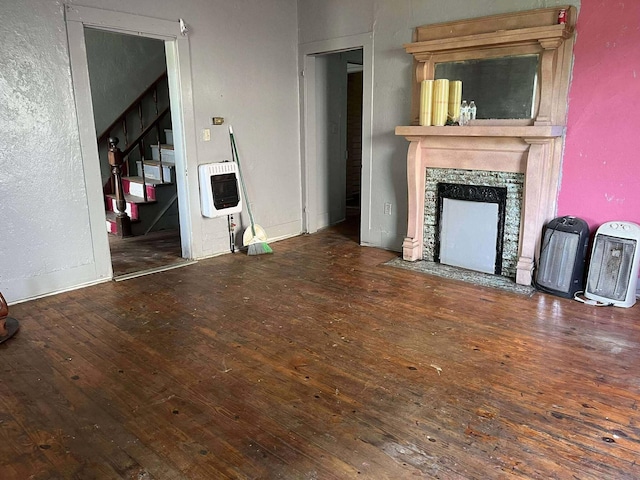 207 E 2nd N St, Morristown, TN 37814 - unfurnished living room featuring heating unit, hardwood / wood-style flooring, stairs, and a high end fireplace