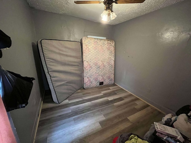 207 E 2nd N St, Morristown, TN 37814 - unfurnished bedroom featuring a textured ceiling, wood finished floors, and a ceiling fan