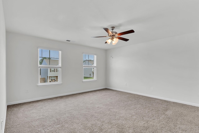 spare room featuring carpet flooring and ceiling fan