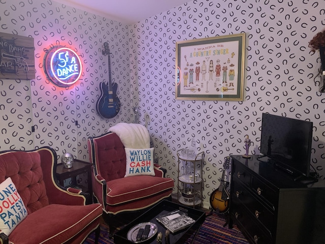 sitting room featuring wallpapered walls