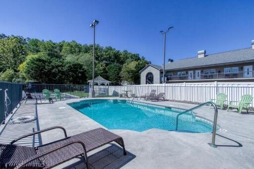 pool featuring a patio area and fence