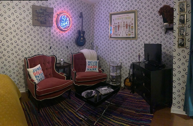 sitting room with wallpapered walls