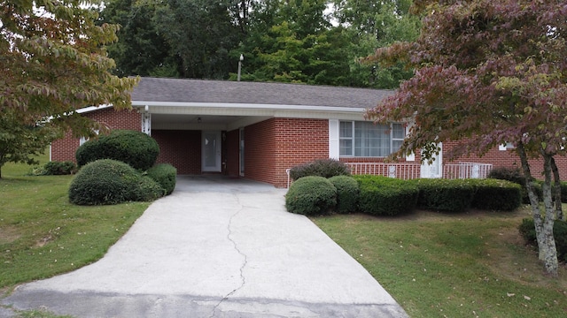 ranch-style home with a front yard and a carport