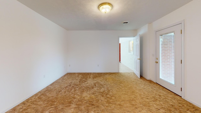 carpeted spare room featuring a healthy amount of sunlight