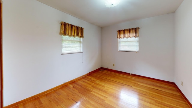 empty room with hardwood / wood-style floors