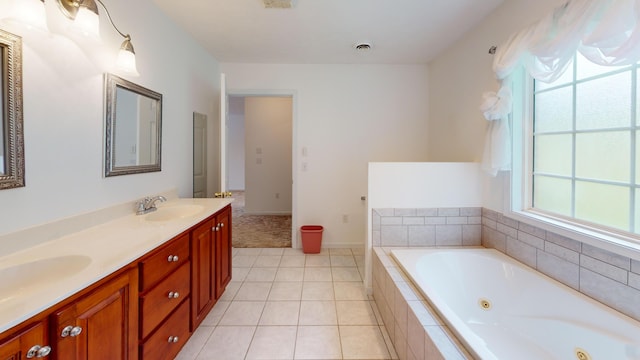 bathroom featuring vanity, tile patterned floors, and tiled tub