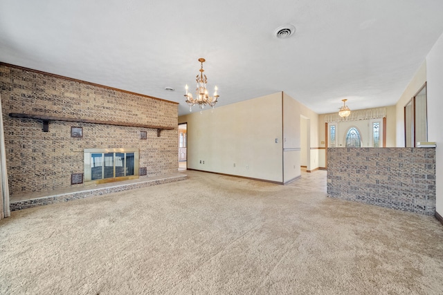 unfurnished living room featuring light colored carpet, a notable chandelier, and a fireplace