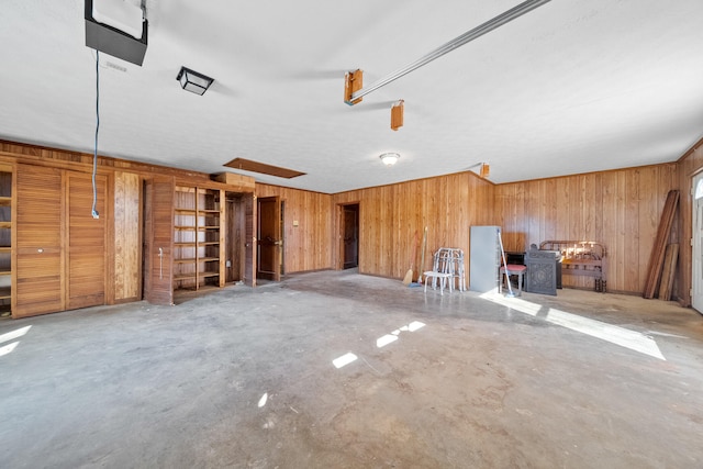 miscellaneous room featuring wooden walls and concrete floors