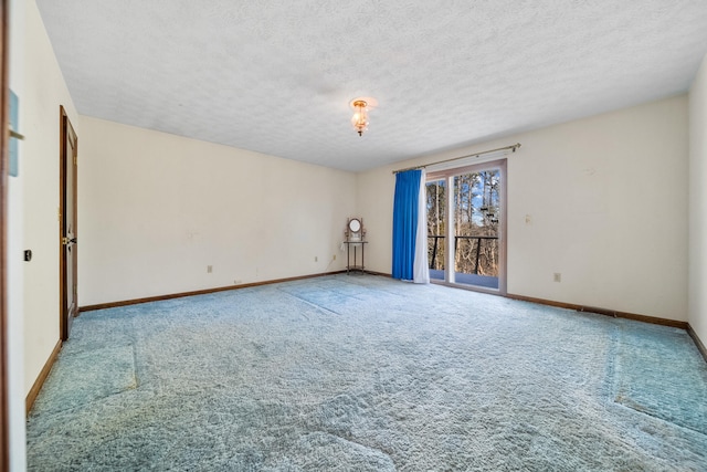 unfurnished room with carpet floors and a textured ceiling