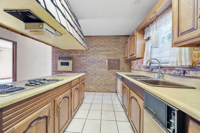 kitchen featuring sink, light tile patterned floors, stovetop, and dishwasher