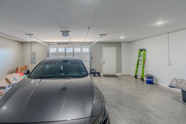 garage with a garage door opener and electric panel