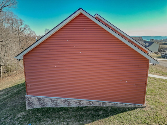 view of side of home with a yard