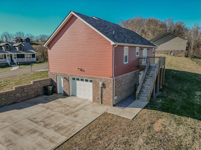 view of side of property with a garage and a lawn