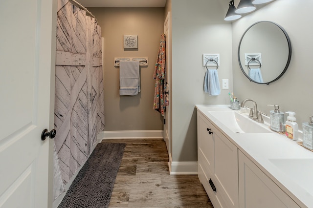 bathroom featuring hardwood / wood-style flooring and vanity