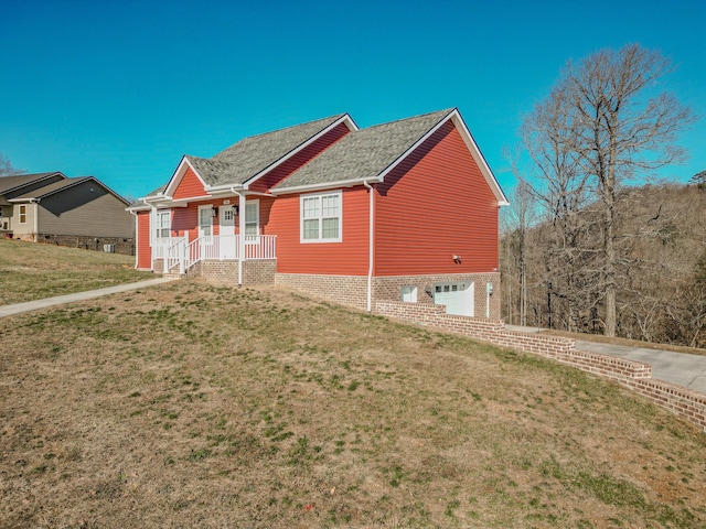 view of front of house with a front yard and a garage