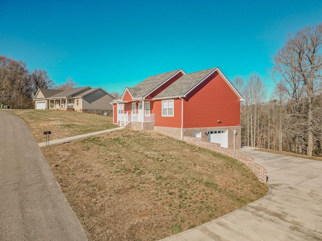 view of front of house featuring a porch, a front yard, and a garage