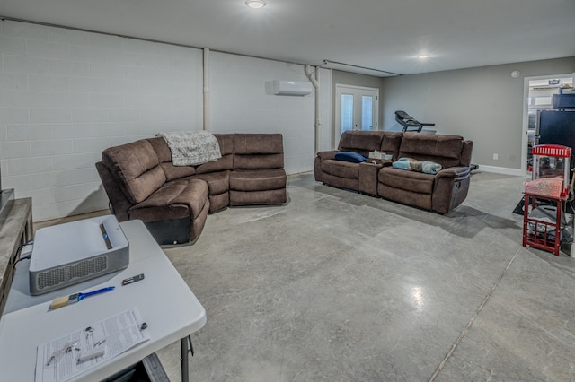 living room featuring a wall mounted AC, french doors, and concrete flooring