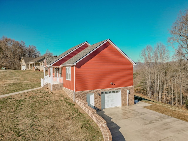 view of side of property with a lawn and a garage