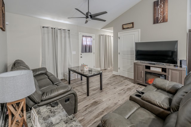 living room with light wood-type flooring, ceiling fan, and lofted ceiling