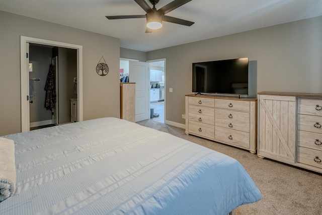 bedroom featuring ensuite bathroom, ceiling fan, and light colored carpet