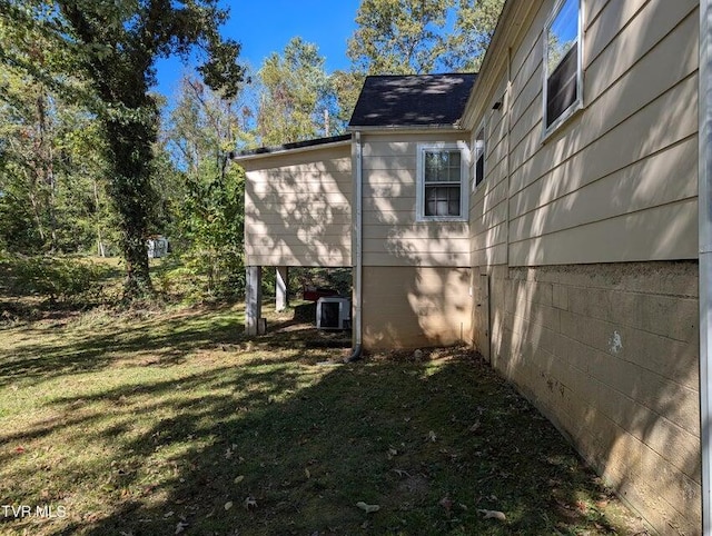 view of home's exterior featuring a yard and central AC unit