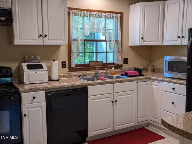 kitchen featuring white cabinets, exhaust hood, sink, and black appliances